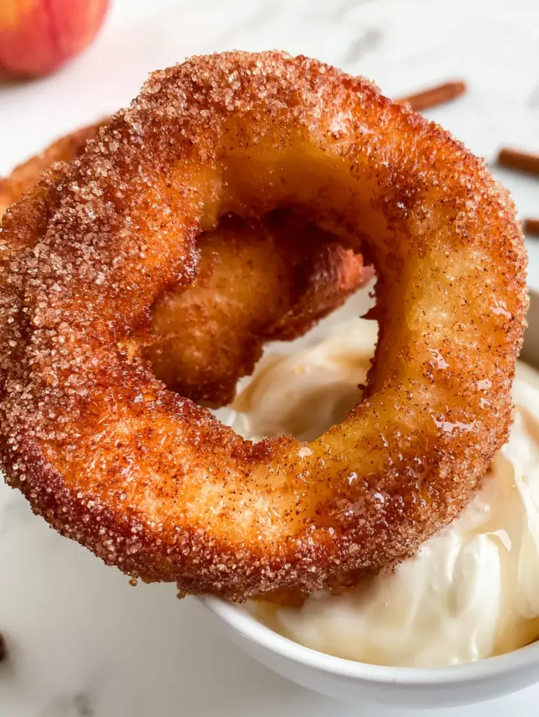 Close-up of the texture of Air Fryer Cinnamon Apple Rings showing the tender center and heavy cinnamon sugar coating.